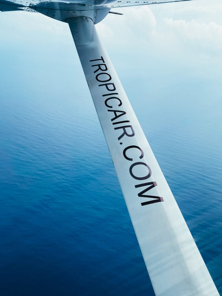 An airplane wing support beam that reads TROPICAIR.COM