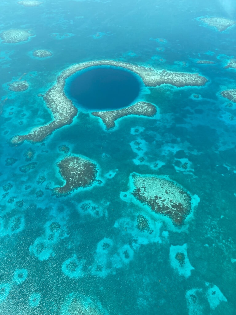 Exactly How to Fly Over the Blue Hole in Belize