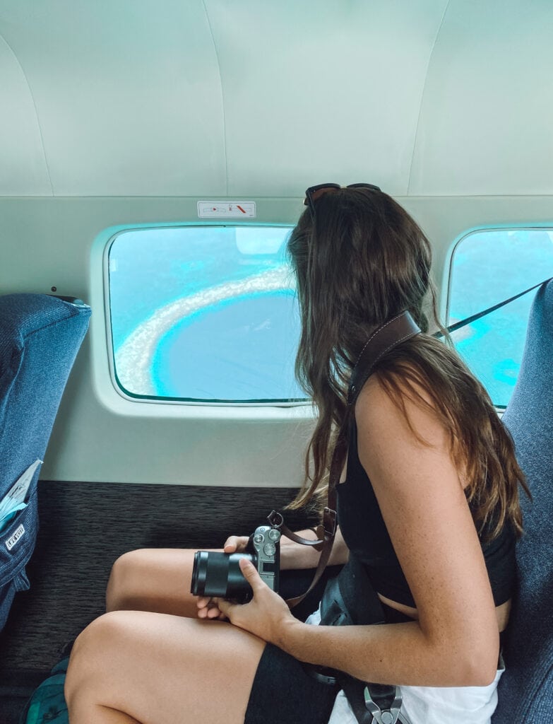 Sarah looks out plane window at the Blue Hole