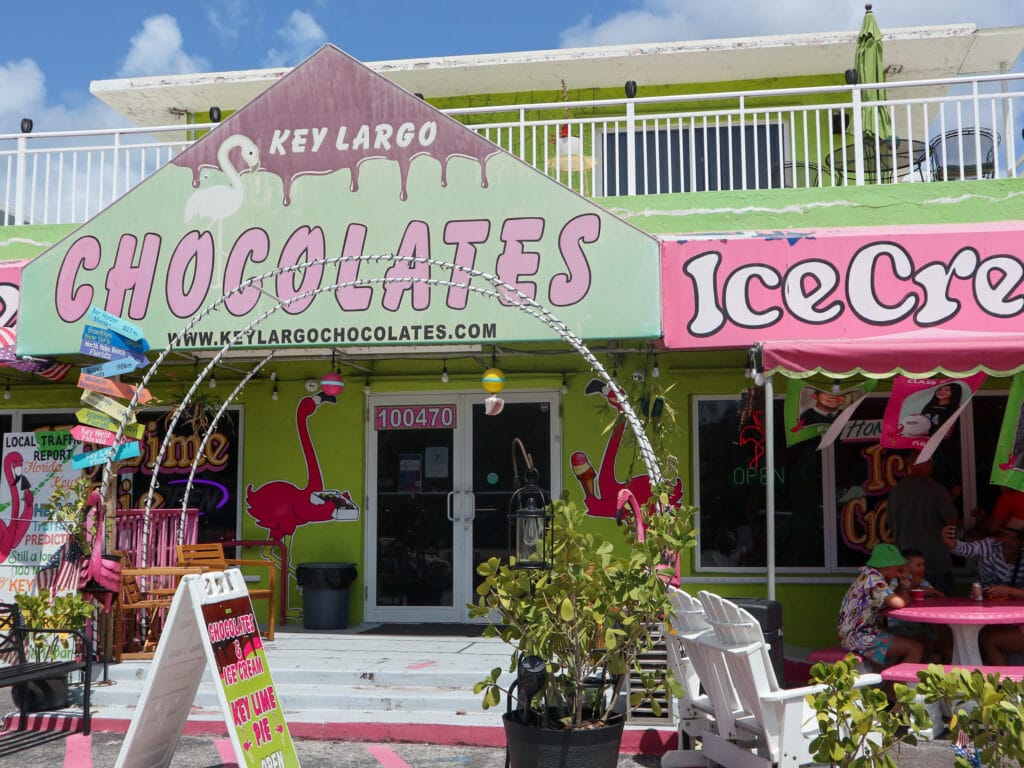 Green brown and pink signage outside a restaurant that reads key largo chocolates.
