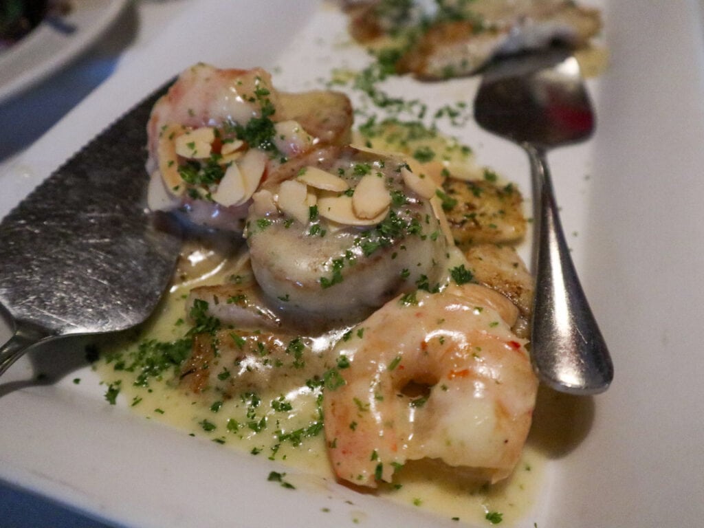 A plate of shrimp and scallops and fish covered in cream - gluten free restaurants florida keys.