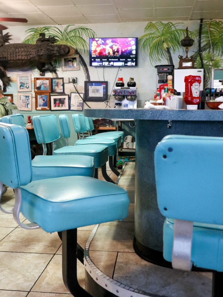 Blue chairs at a diner bar.