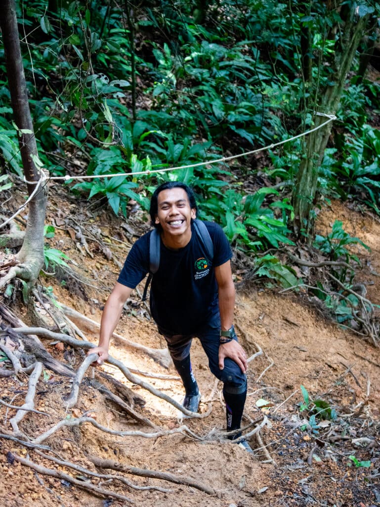 Tyson, owner of Sumatra Orangutan Discovery Villa, smiles in the jungle