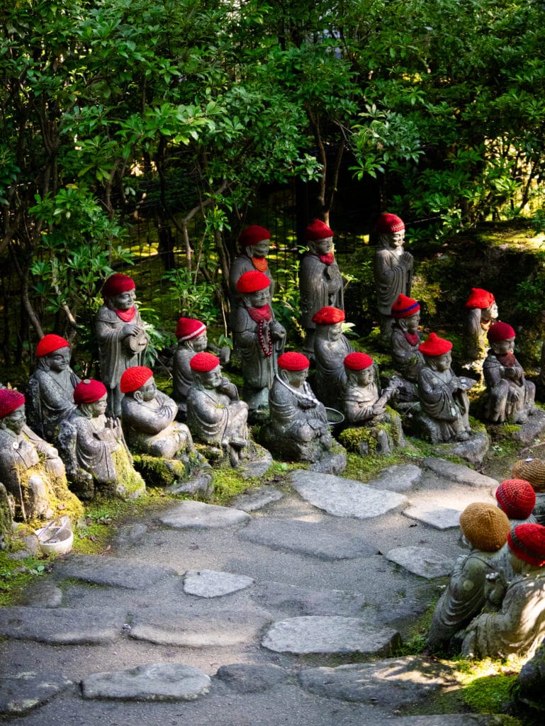 Daisho in temple walkway with statues.
