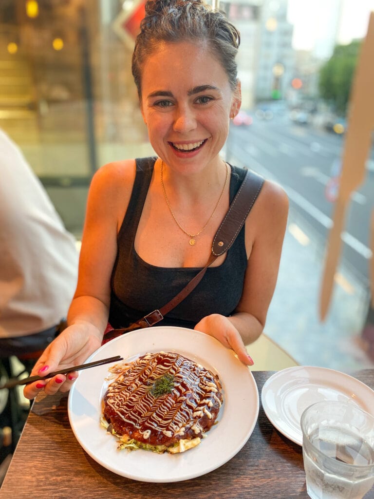 Sarah smiles with her gluten free okonomiyaki