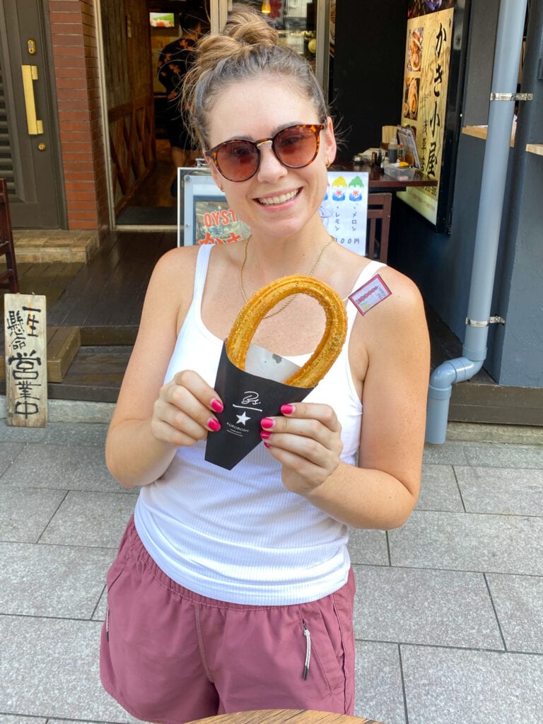 Sarah with gluten free churro in Tokyo