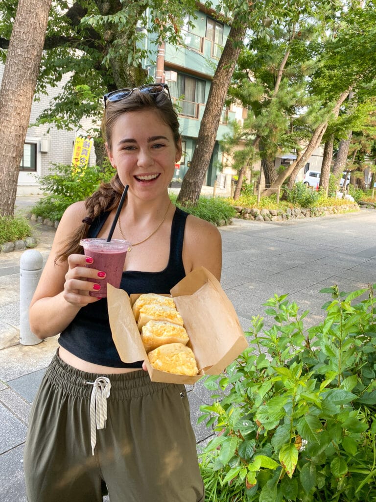 Sarah holds smoothie and egg sandwiches from Comme'N Gluten Free in Tokyo.