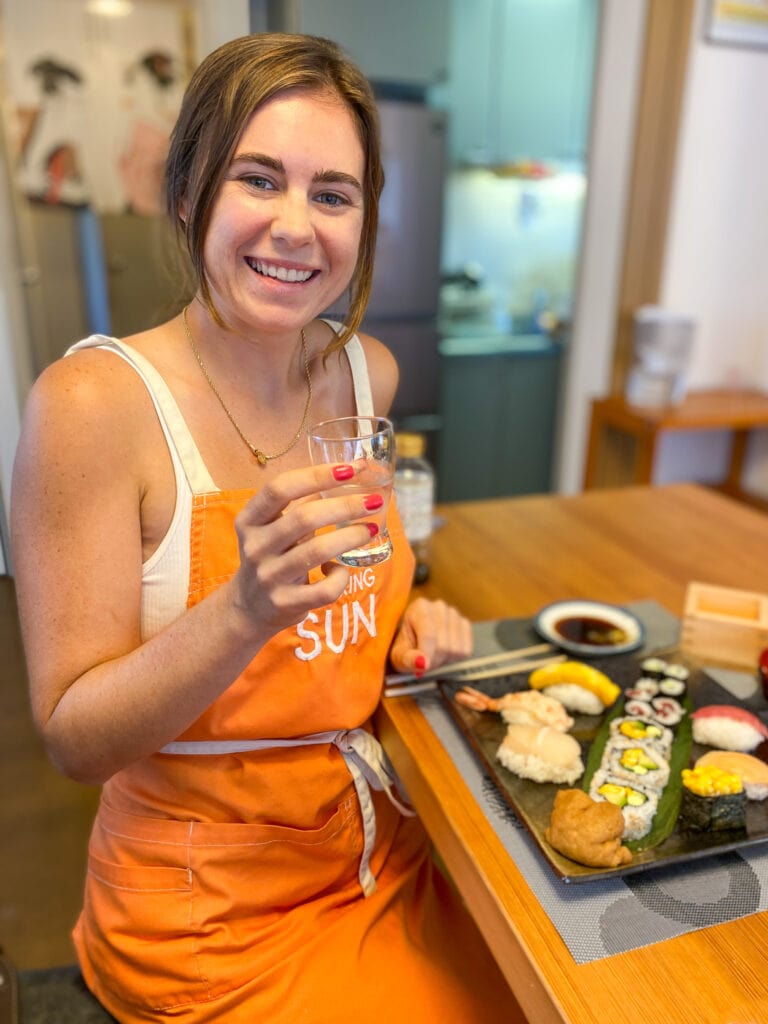 Sarah smiles with sushi.