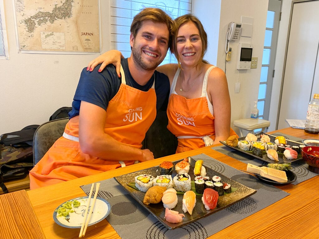 Sarah and Dan smile with their sushi.