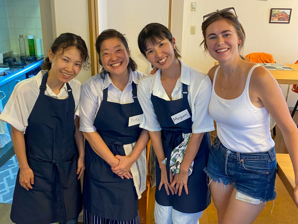 Sarah smiles with three Japanese sushi class teachers from Cooking Sun.