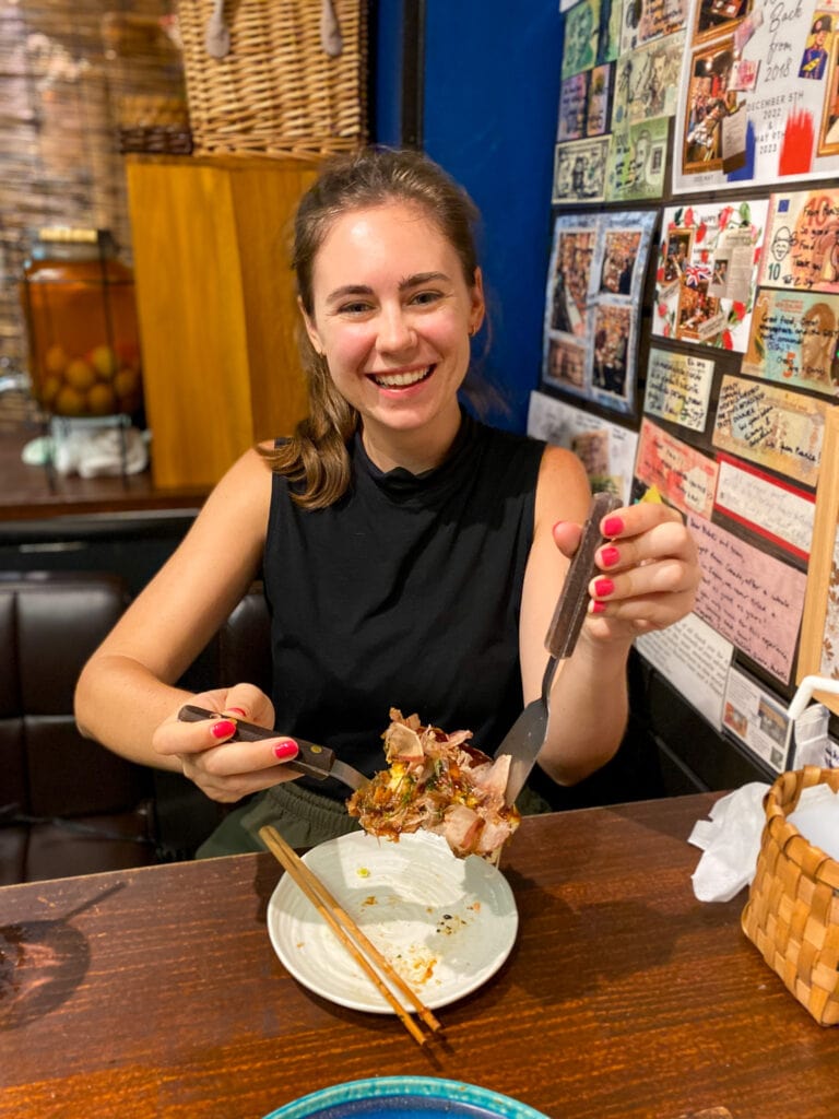 Sarah smiles with her gluten free okonomiyaki.