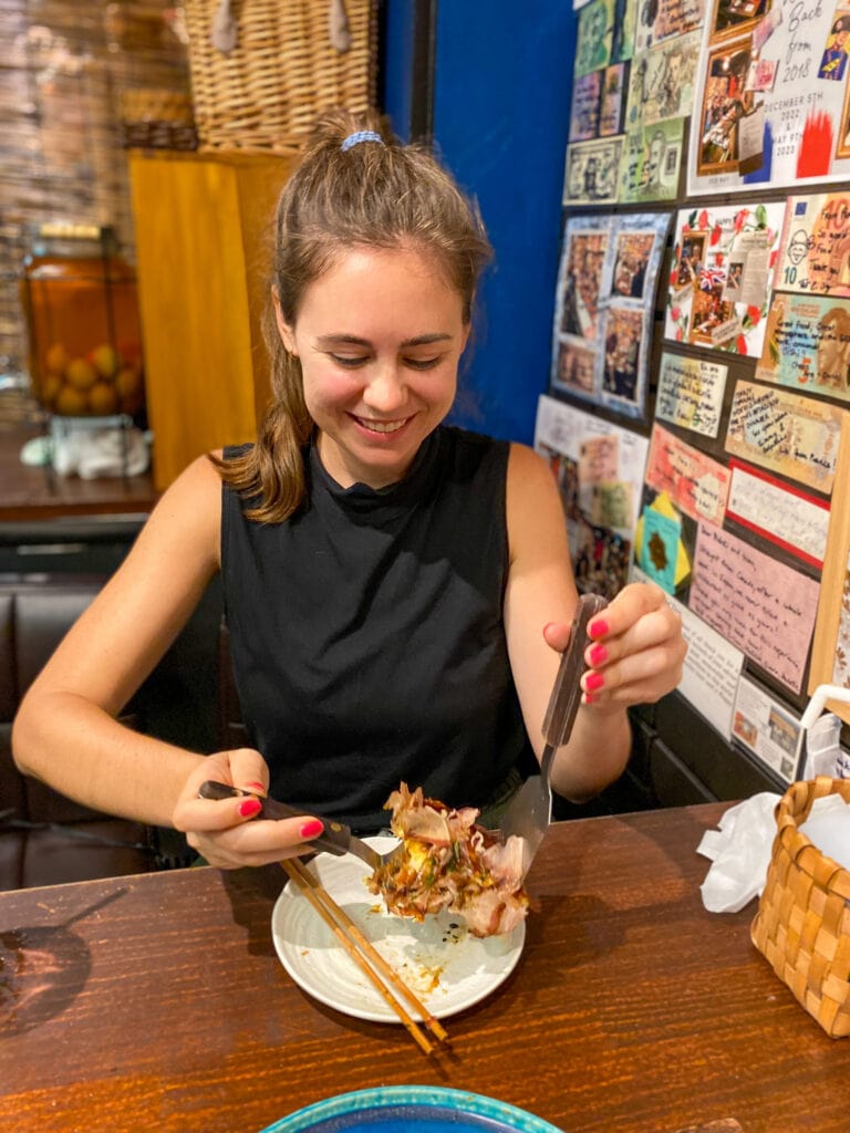 Sarah looks down at her gluten free okonomiyaki