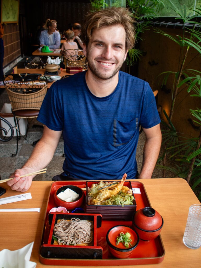 Dan smiles with his meal.