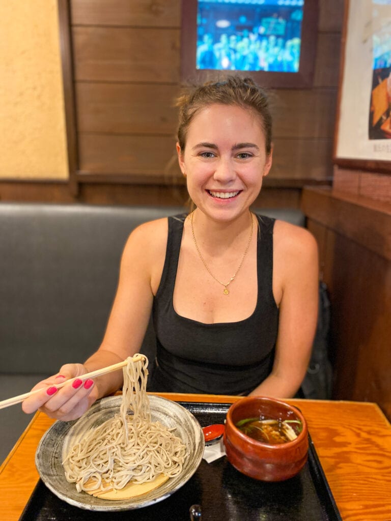 Sarah smiles with gluten free soba in Osaka Japan.