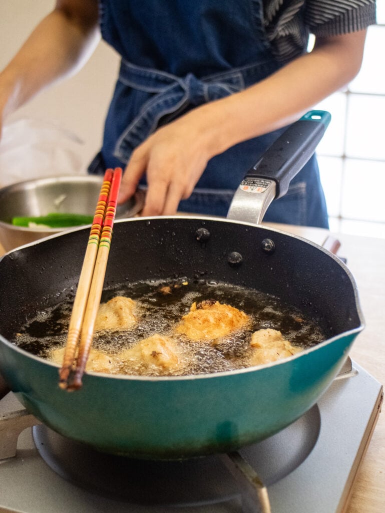 Yukiko and pot of oil frying karaage