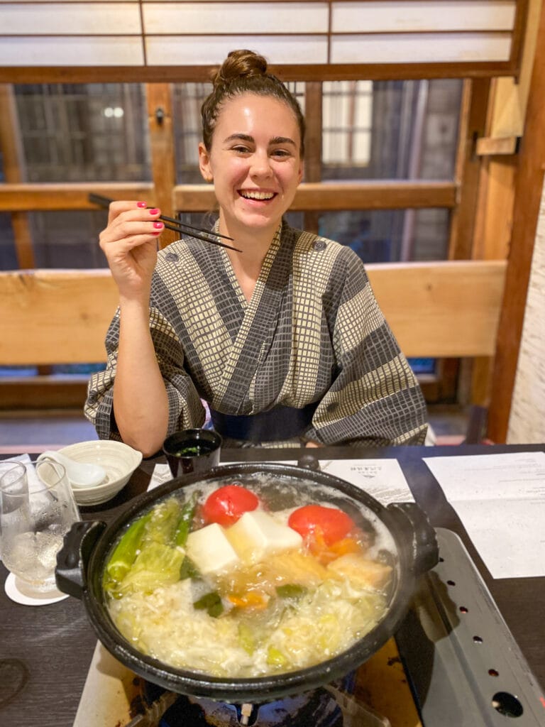 Sarah smiling with chopsticks and shabu shabu