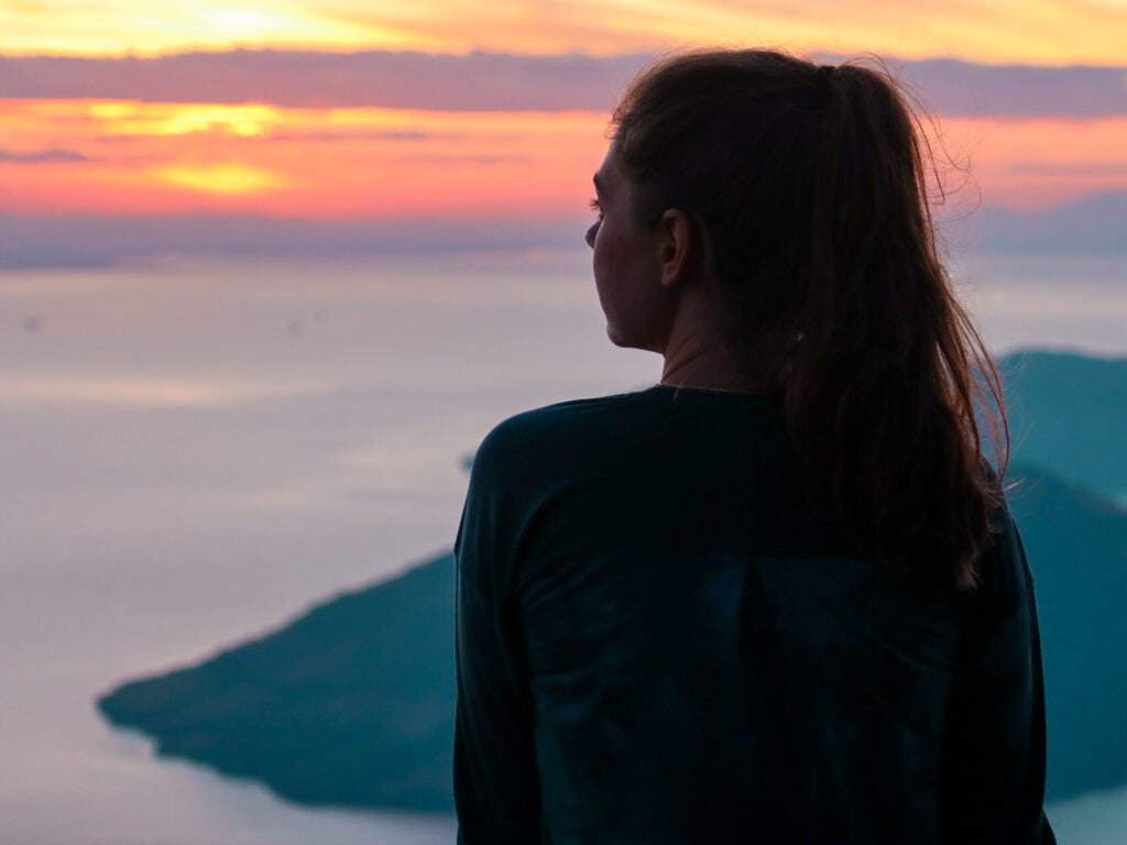 sarah sits and watches sunrise over gulf of fonseca