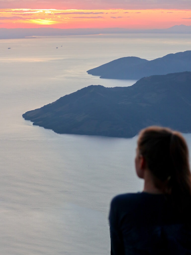 sarah sits and watches sunrise over gulf of fonseca