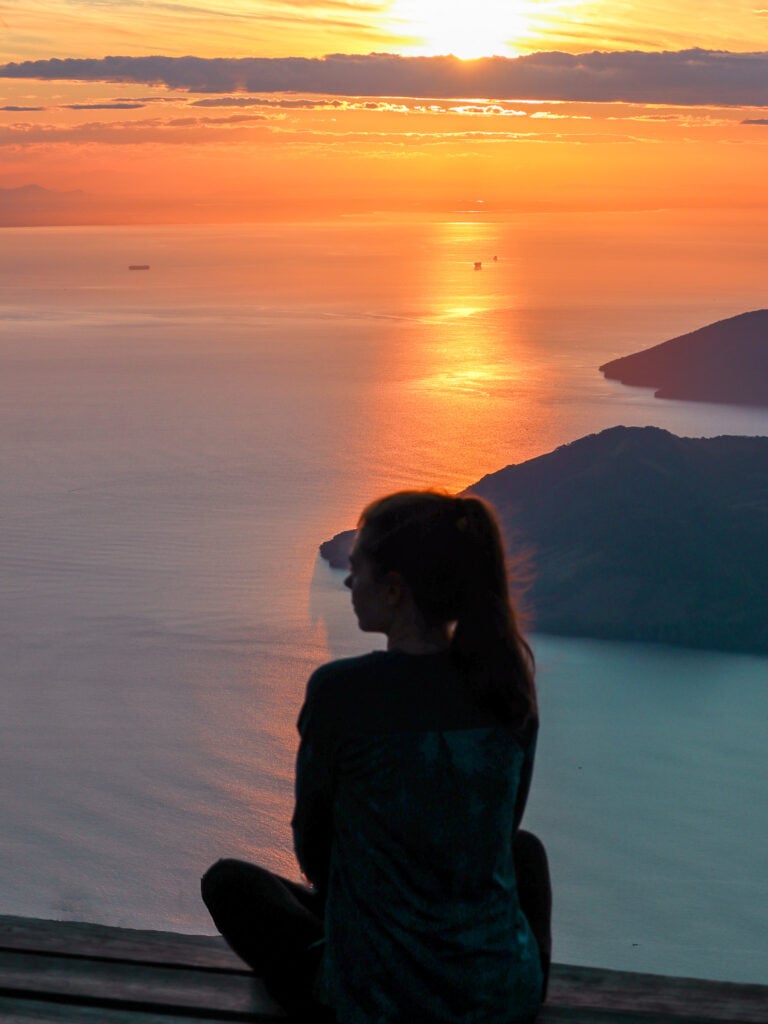 sarah sits and watches sunrise over gulf of fonseca