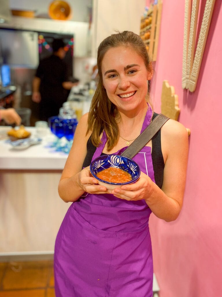 Sarah holding salsa at mexico city cooking class