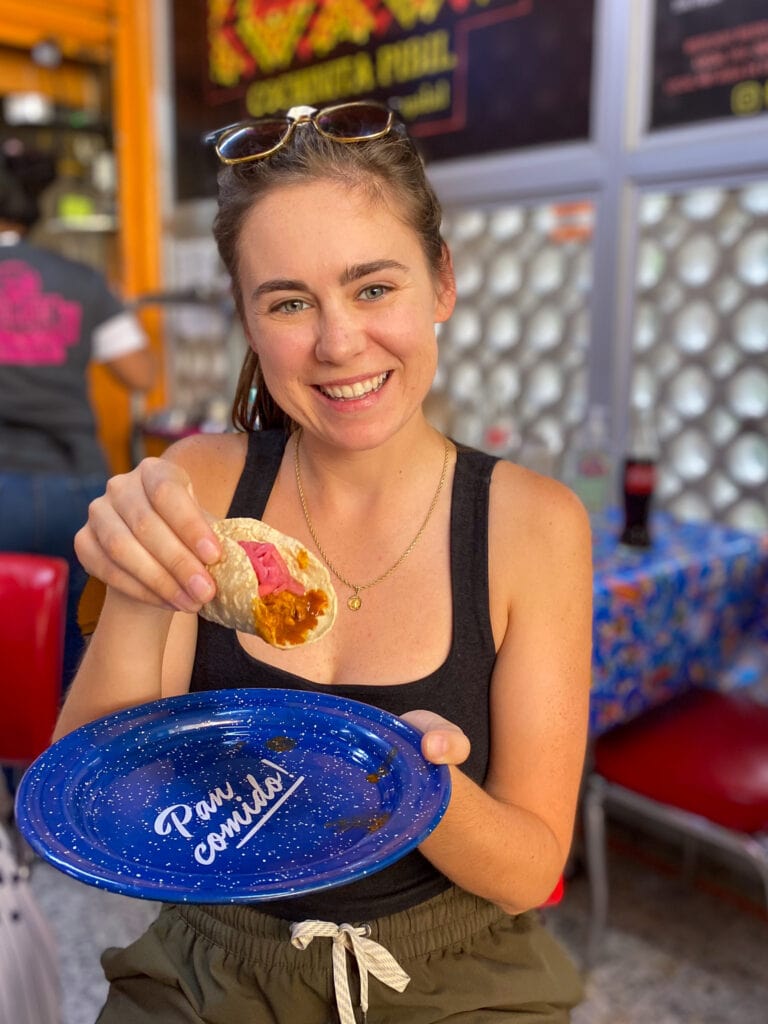 Sarah smiling with tacos on Mexico City taco tour