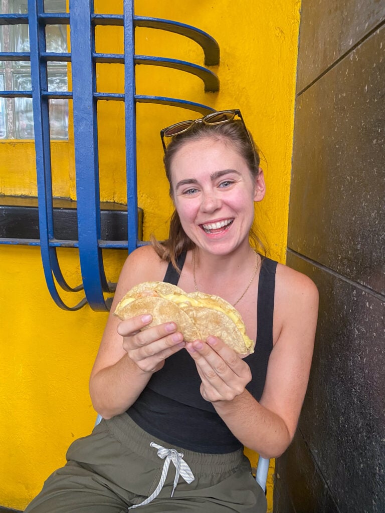 Sarah smiles with taco on taco tour in Mexico City