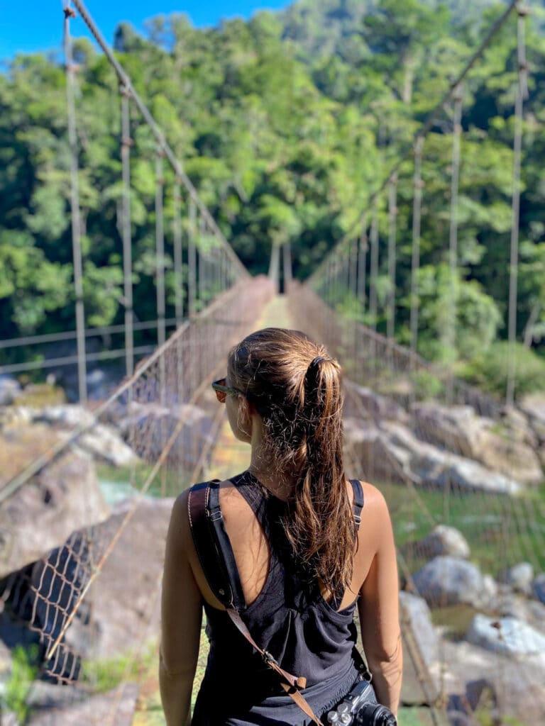 Sarah walks bridge into Pico Bonito National Park