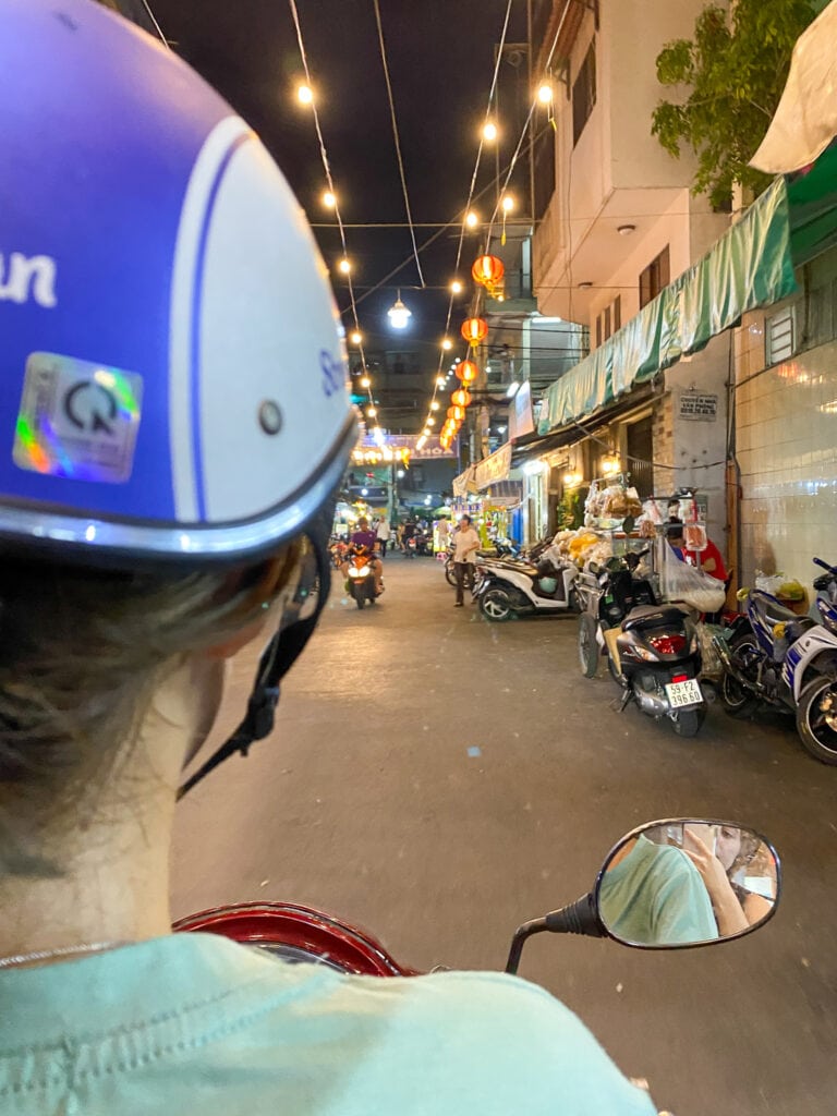 riding motorbike through an alley in Ho Chi Minh on street food tour