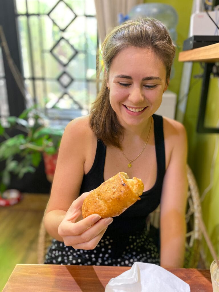 Sarah eating gluten free pain au chocolat in ho chi minh vietnam