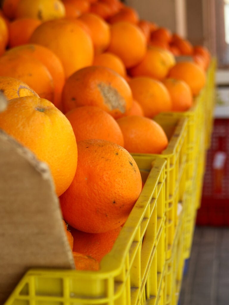 oranges in yellow crates