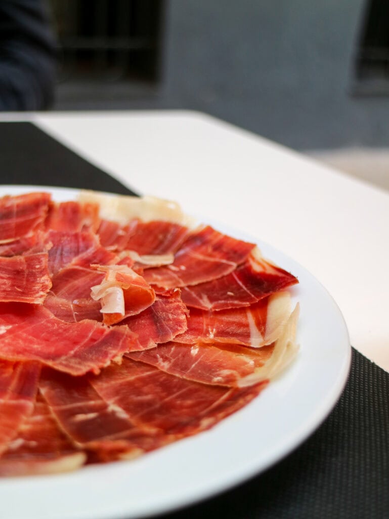 serrano ham on white plate