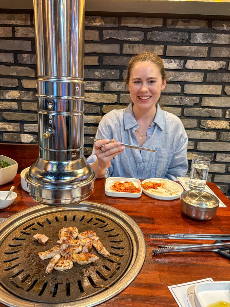 Sarah smiling while doing gluten free KBBQ in Seoul.