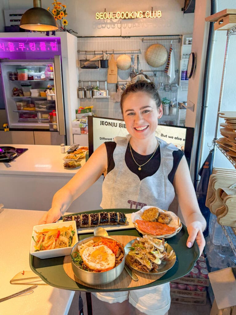 Sarah holding a plate of gluten free Korean food