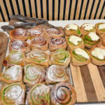 Assorted gluten-free pastries on a wooden serving board.