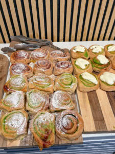 Assorted gluten-free pastries on a wooden serving board.