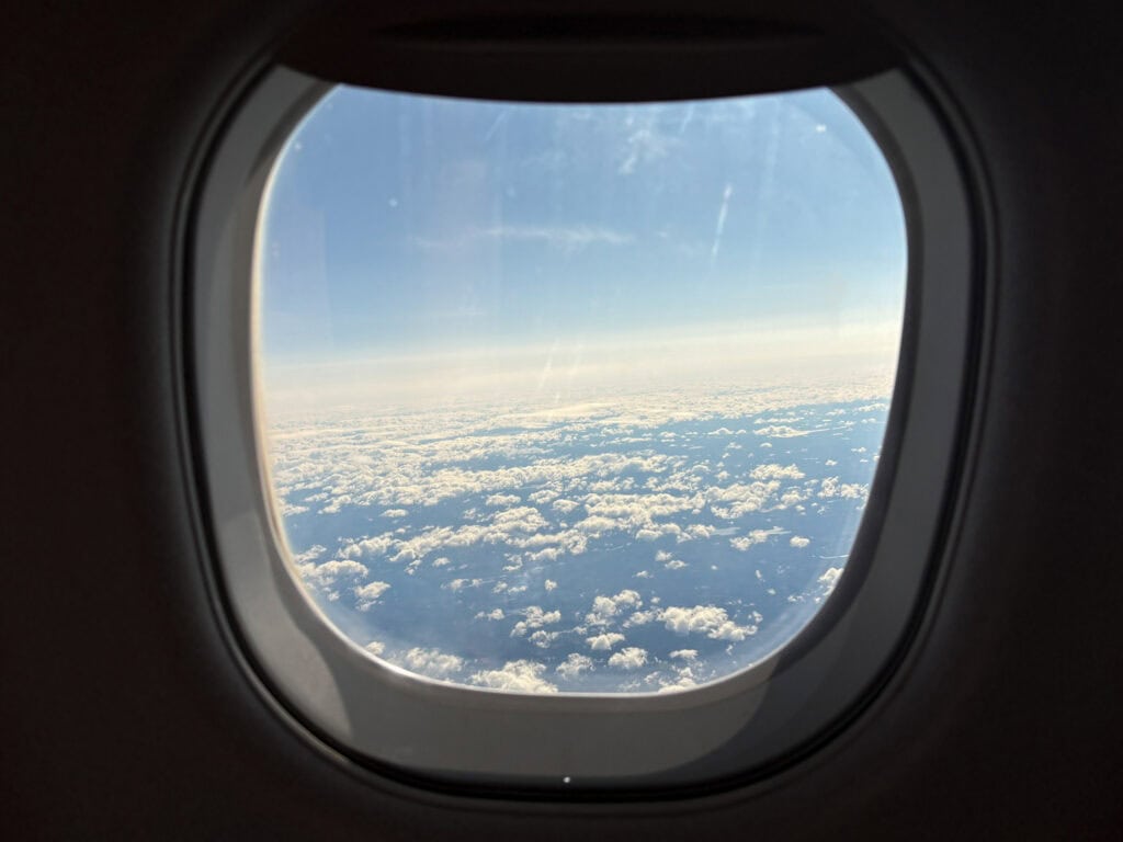 View of clouds from an airplane window during daytime.