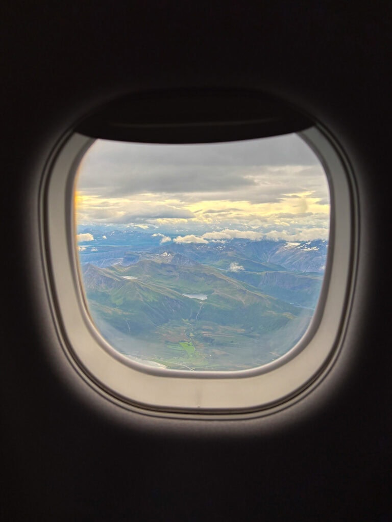 Scenic mountain view seen from an airplane window over Lofoten.