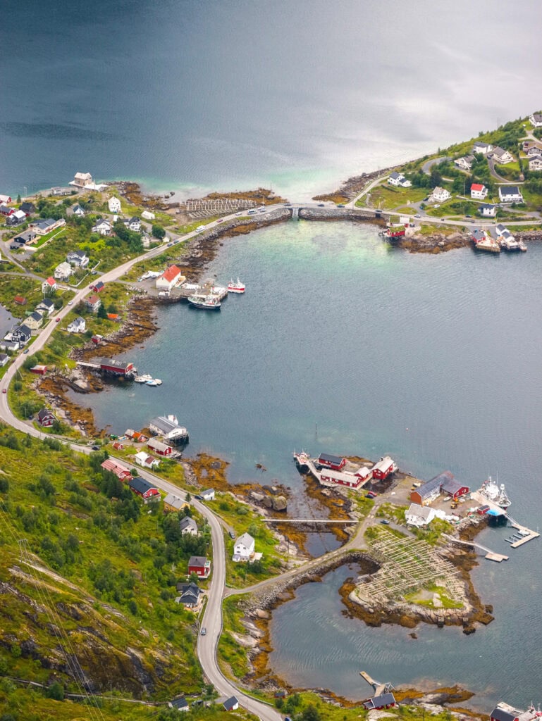 Scenic view of a Norwegian coastal village with boats and a bridge over the water.