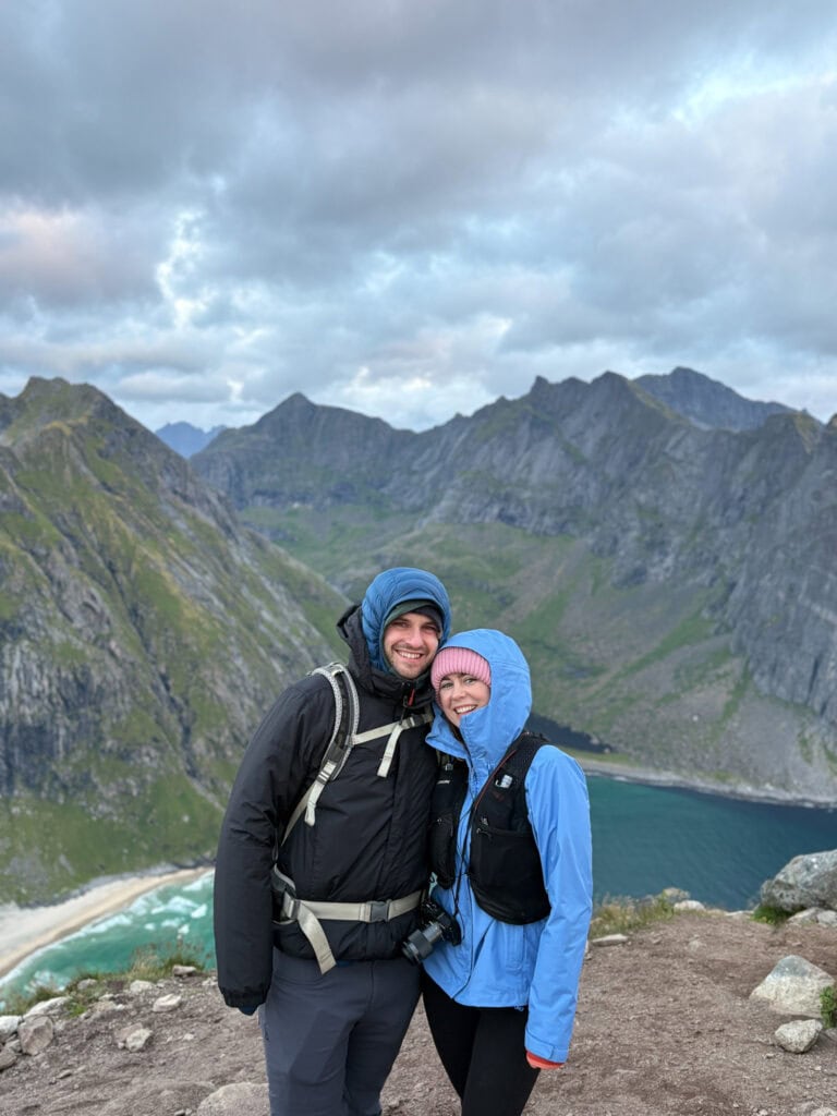 Hikers enjoying Lofoten's scenic mountain and fjord views in Norway.