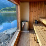 Cozy wooden sauna with lake view in Lofoten, Norway, during daytime.