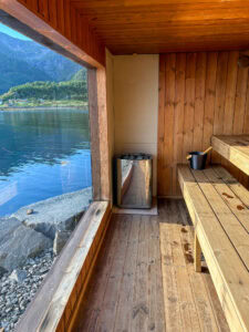 Cozy wooden sauna with lake view in Lofoten, Norway, during daytime.