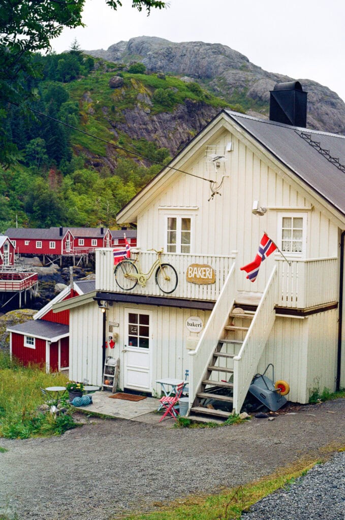 Charming Norwegian house with bicycle and flags in Lofoten, Norway.
