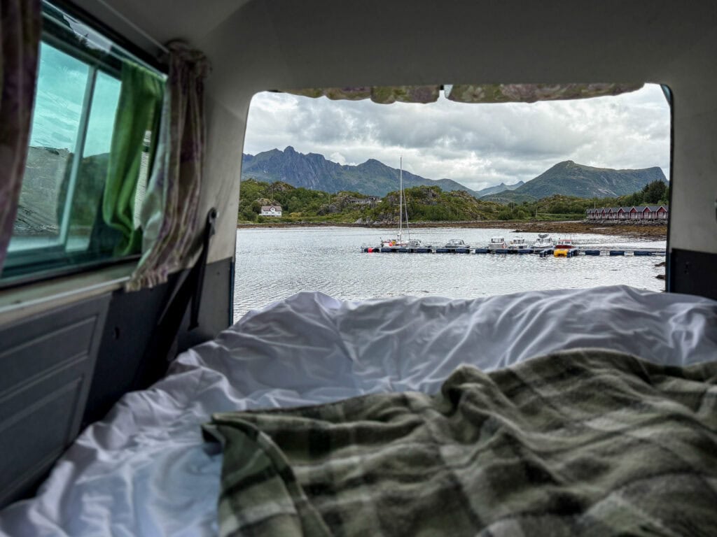 Scenic view of Lofoten mountains from a camper van bed in Norway.