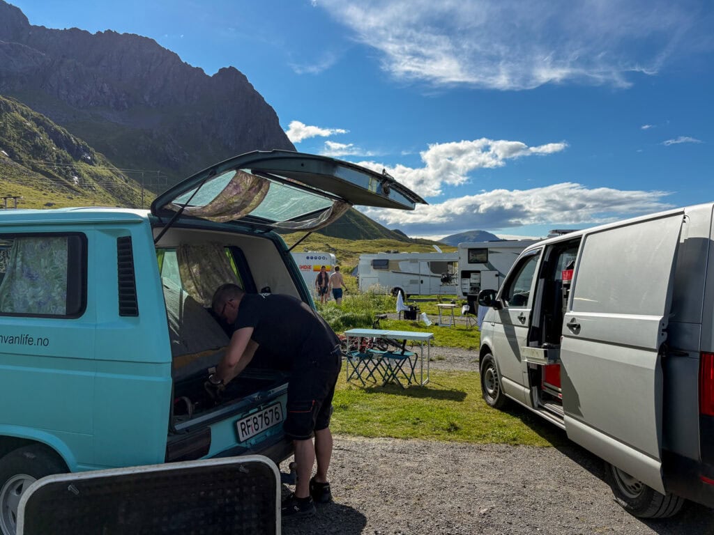 Van life in Lofoten with scenic mountain views and camping setup.