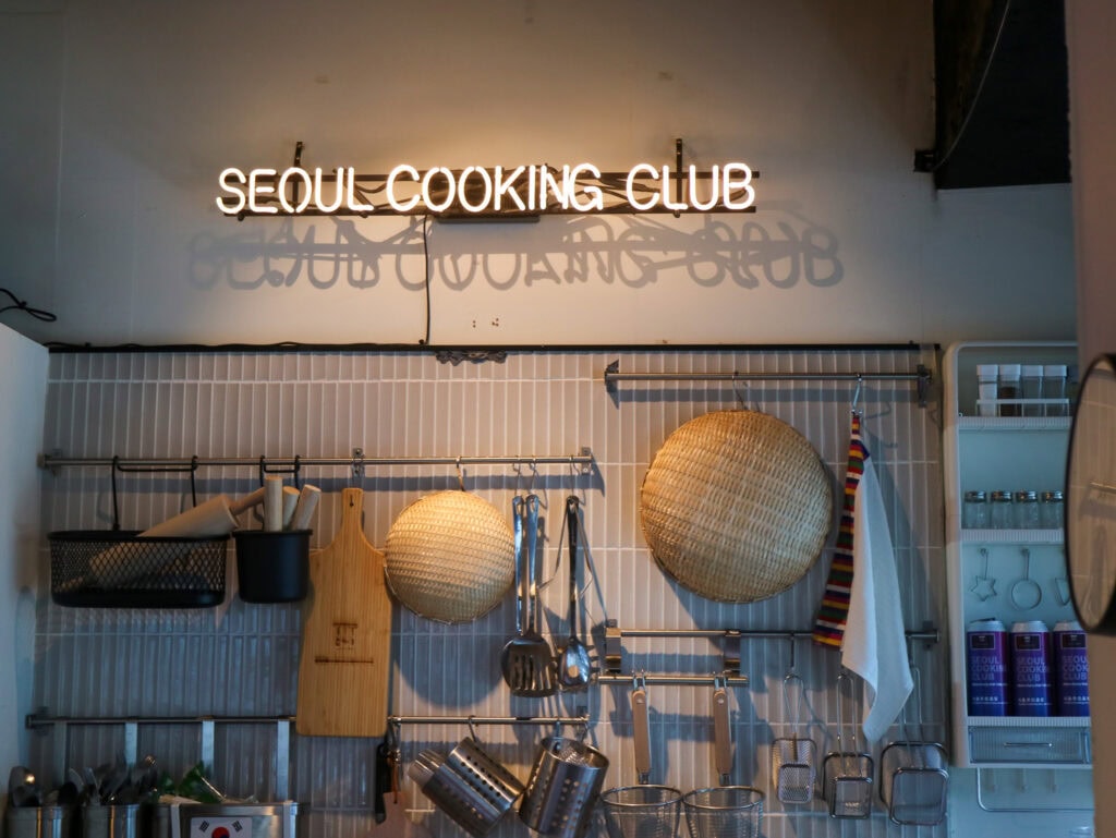 Seoul Cooking Club sign with kitchen utensils and decor in Seoul, South Korea.